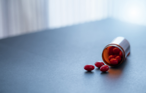 Capsules spilling out of prescription bottle.