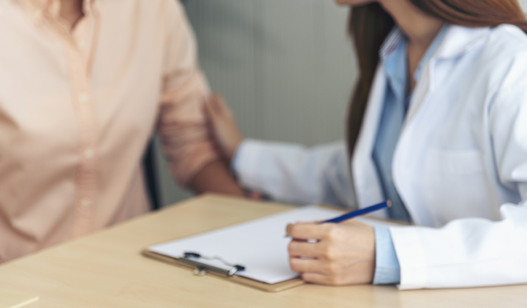 Medical provider assisting patient with paperwork.