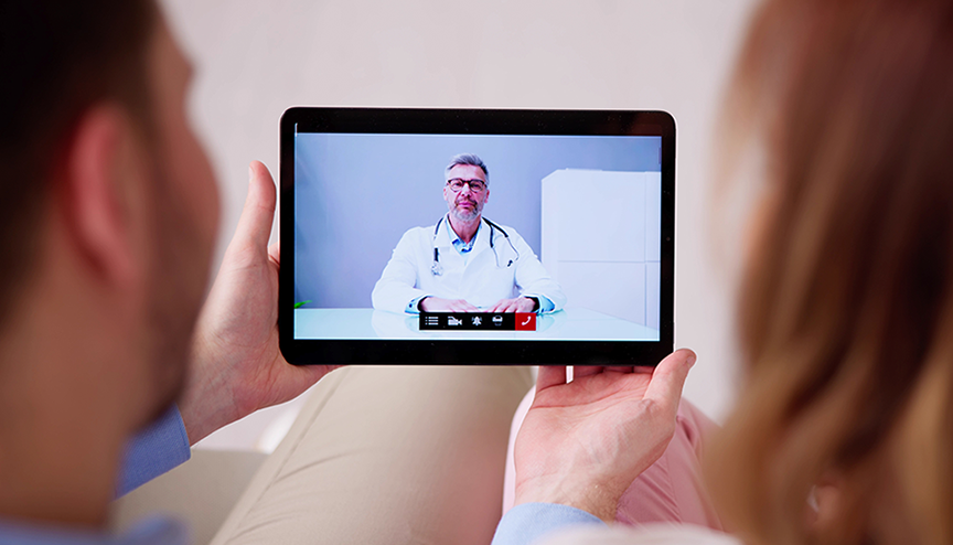 Couple in video chat session with doctor.