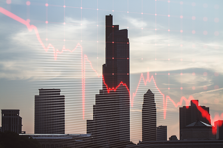 City skyline with overlay of declining stock market chart